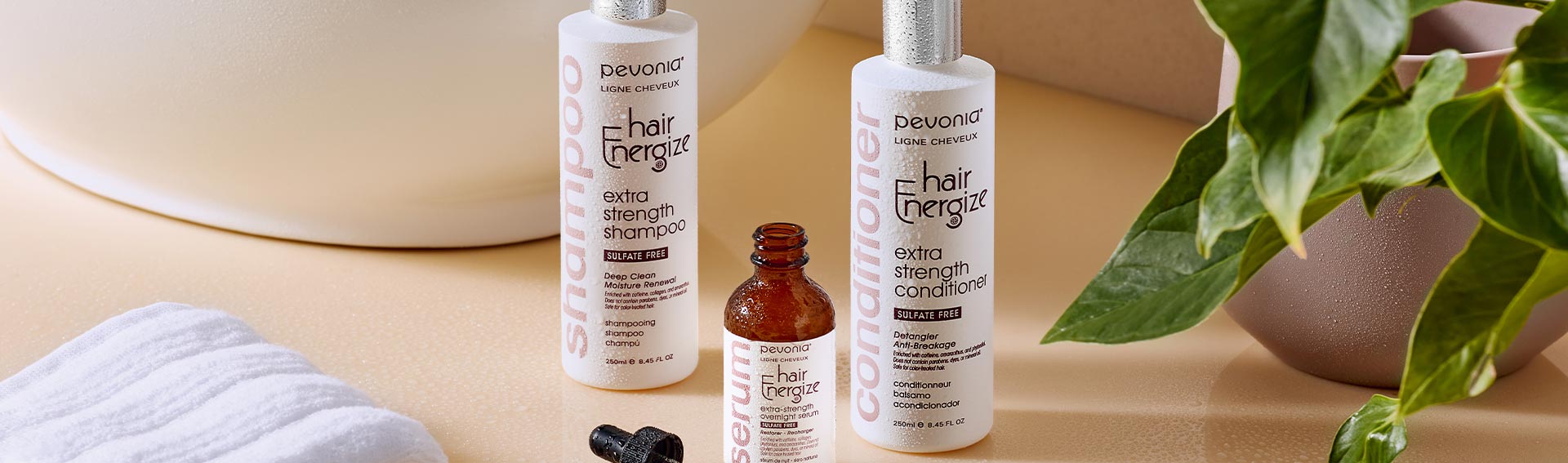 Pevonia Hair Energize Products sitting near a sink and houseplant.