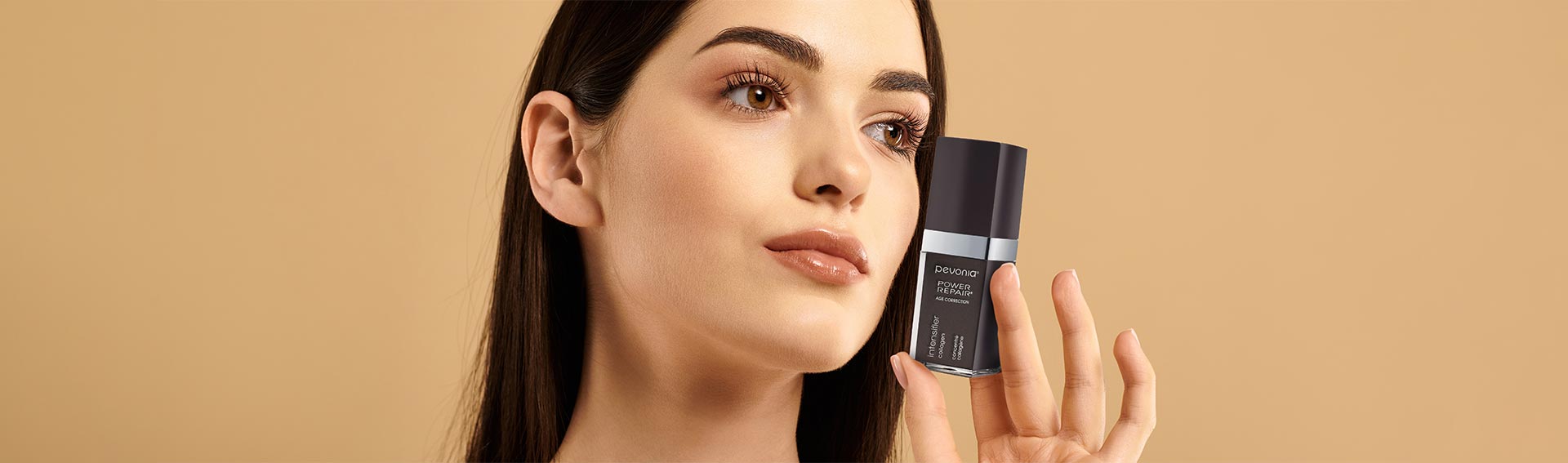 Woman holding Pevonia's Intensifier - Collagen serum.