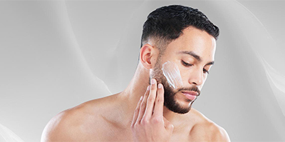 A man applying a Pevonia moisturizer to his face.