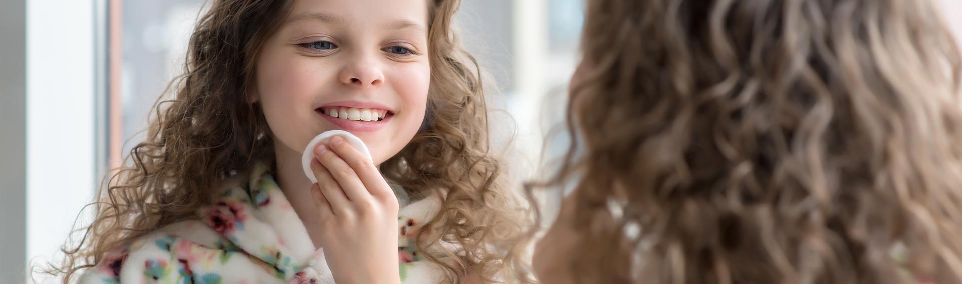 Tween Girl doing Skincare in Mirror